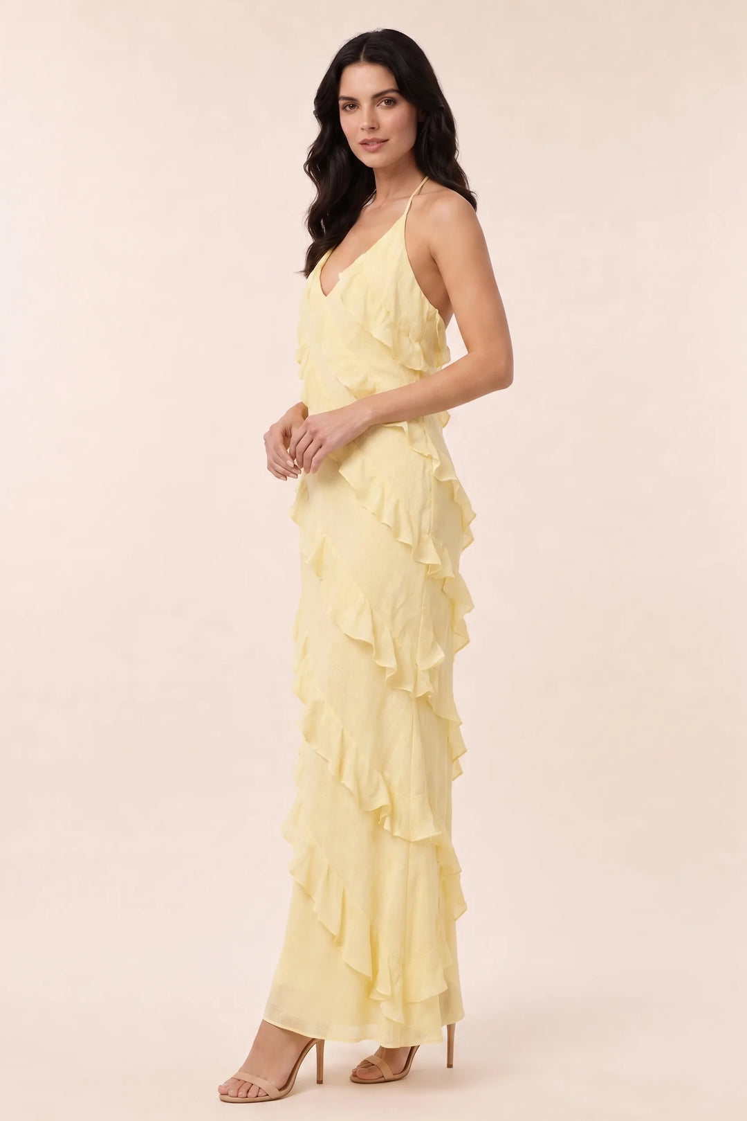 Yellow tiered ruffle halter maxi dress on a model in a three-quarter turn