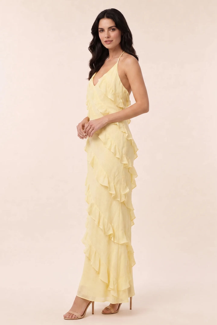 Yellow tiered ruffle halter maxi dress on a model in a three-quarter turn