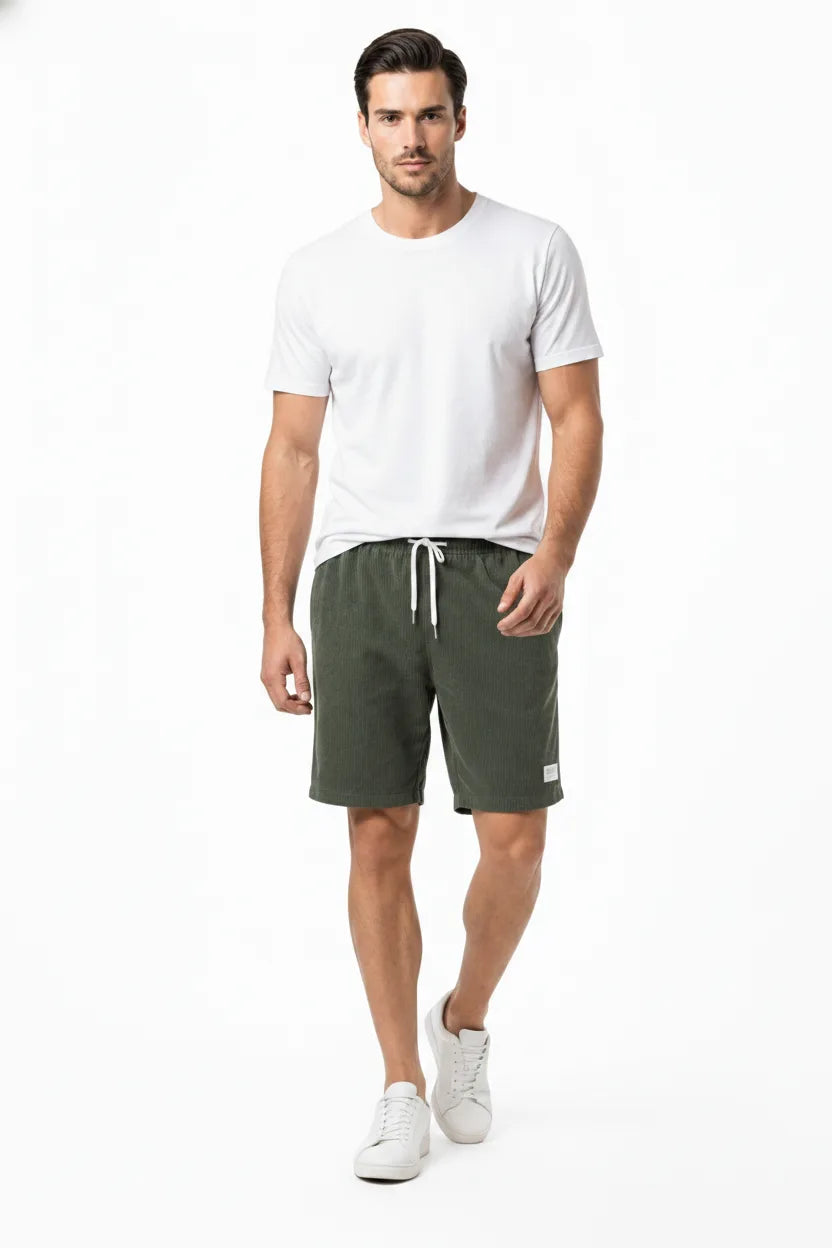 Army green corduroy drawstring shorts on a model in natural movement