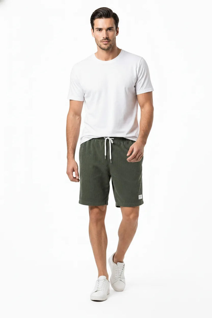 Army green corduroy drawstring shorts on a model in natural movement