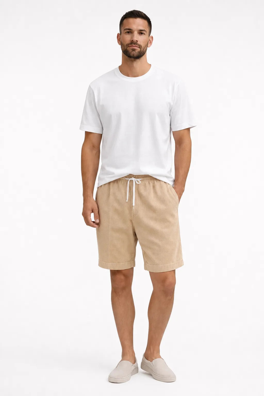 Beige corduroy drawstring shorts on a model in a contrapposto stance