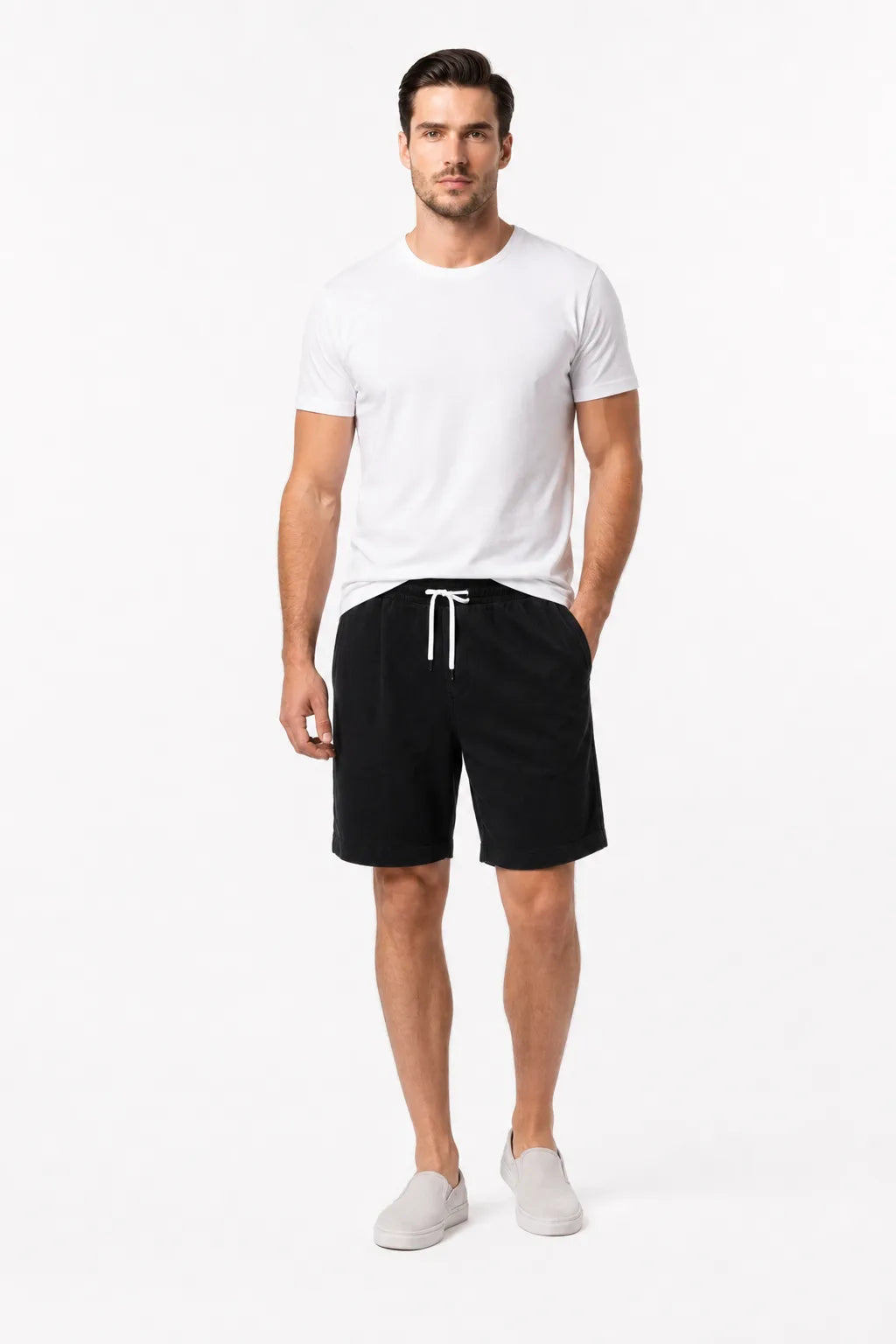 Black corduroy drawstring shorts on a model in a contrapposto stance