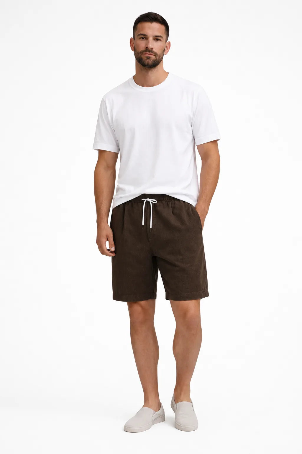 Brown corduroy drawstring shorts on a model in a contrapposto stance