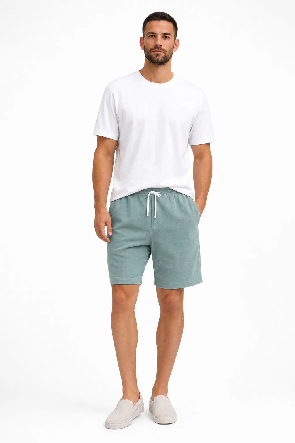 Mint green corduroy drawstring shorts on a model in a contrapposto stance