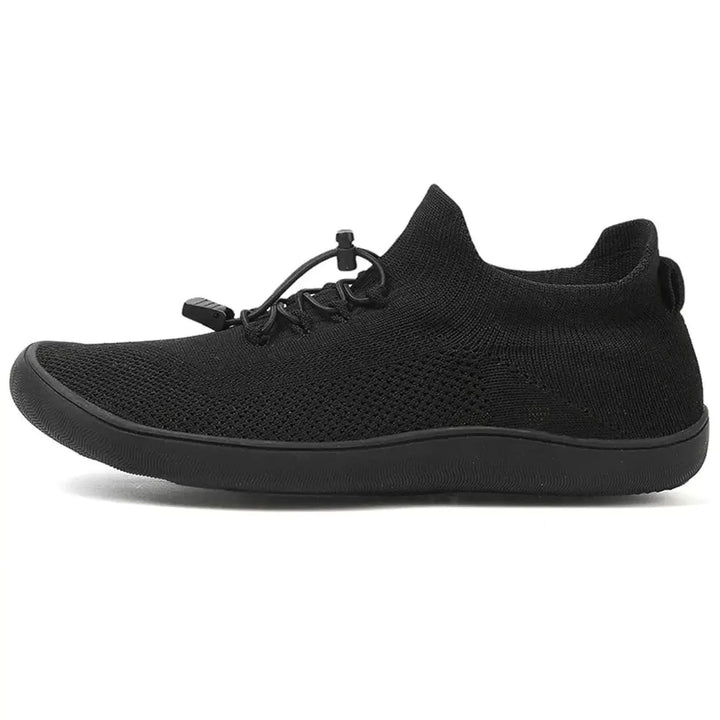 Gray barefoot knit sneaker, on-foot side view
