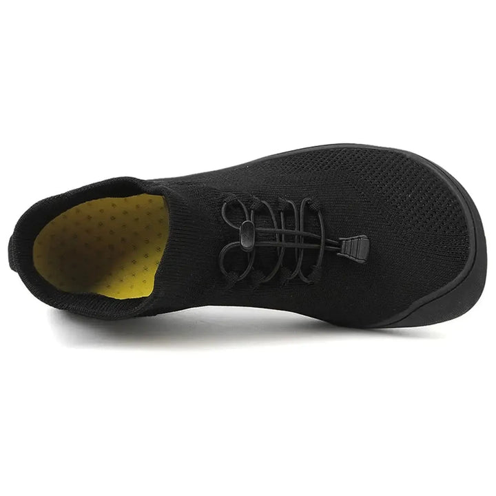 Gray barefoot knit sneaker, on-foot walking view
