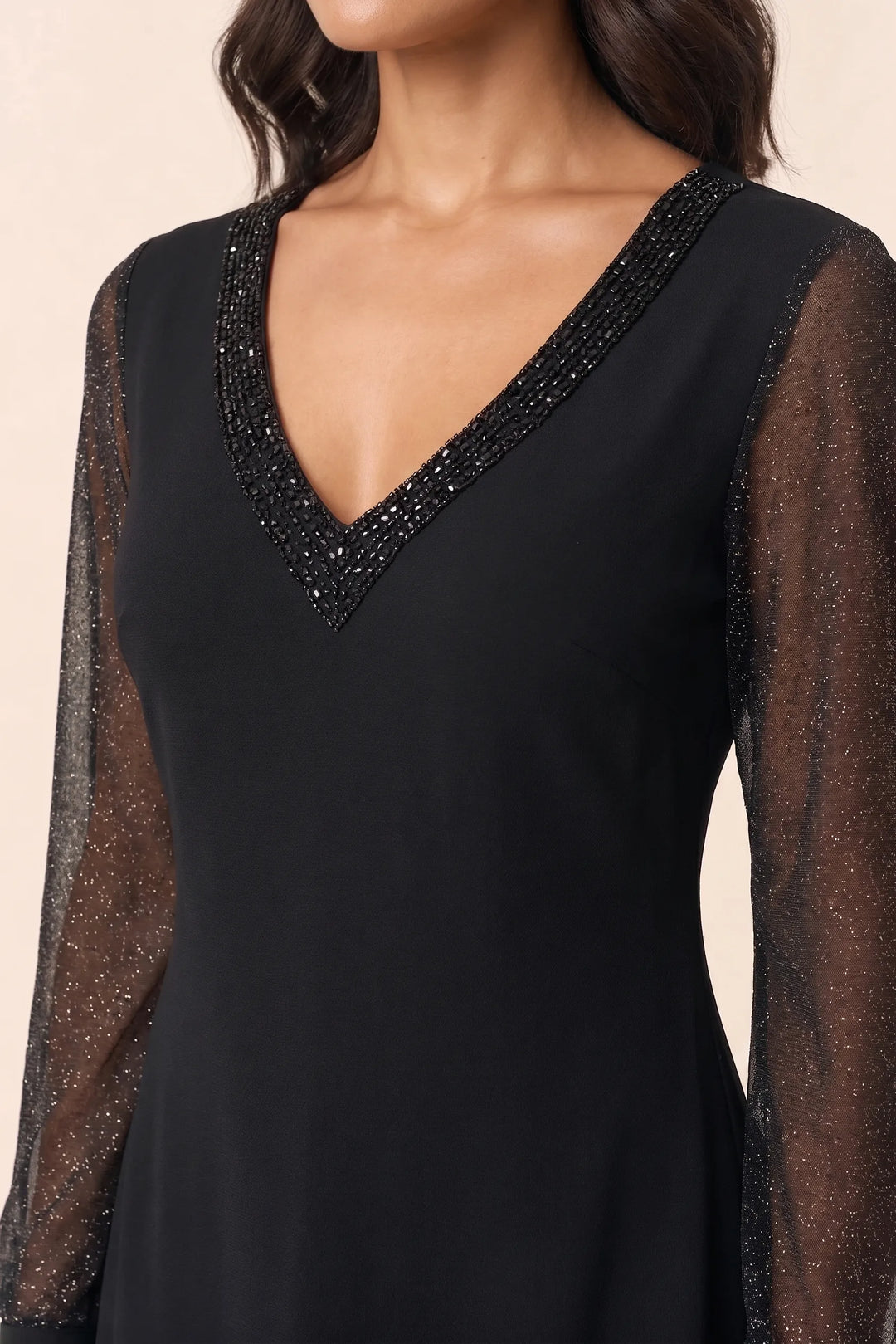 Close-up detail of black glitter mesh sleeve mini dress