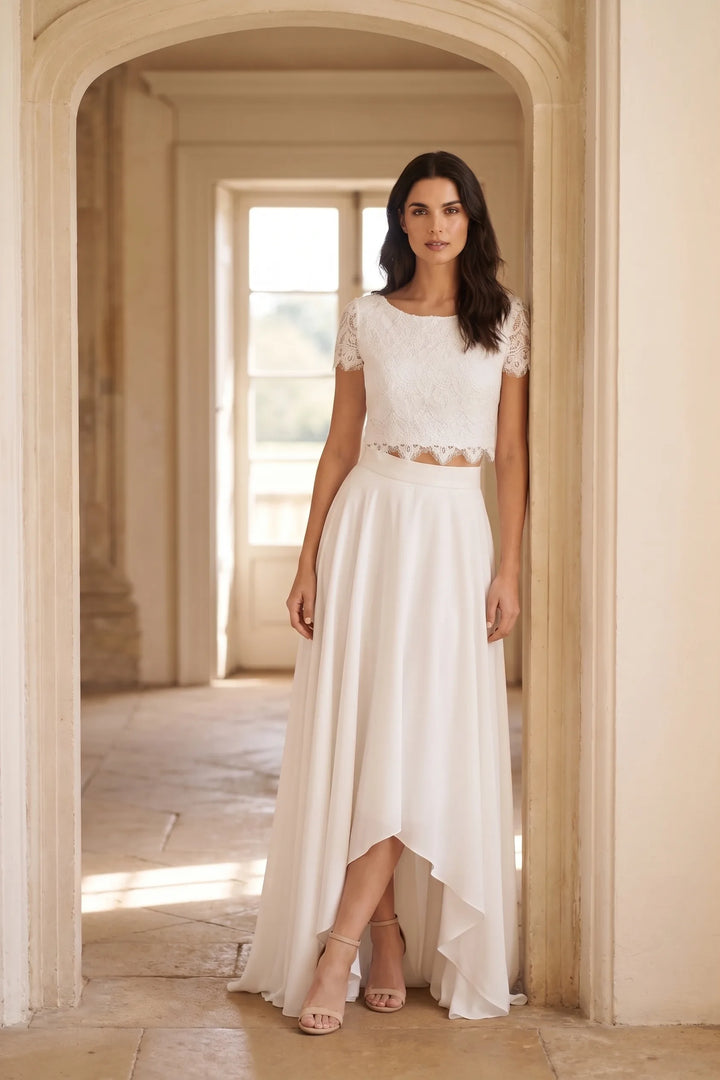 Model wearing a white lace crop top and midi skirt set in a lifestyle setting