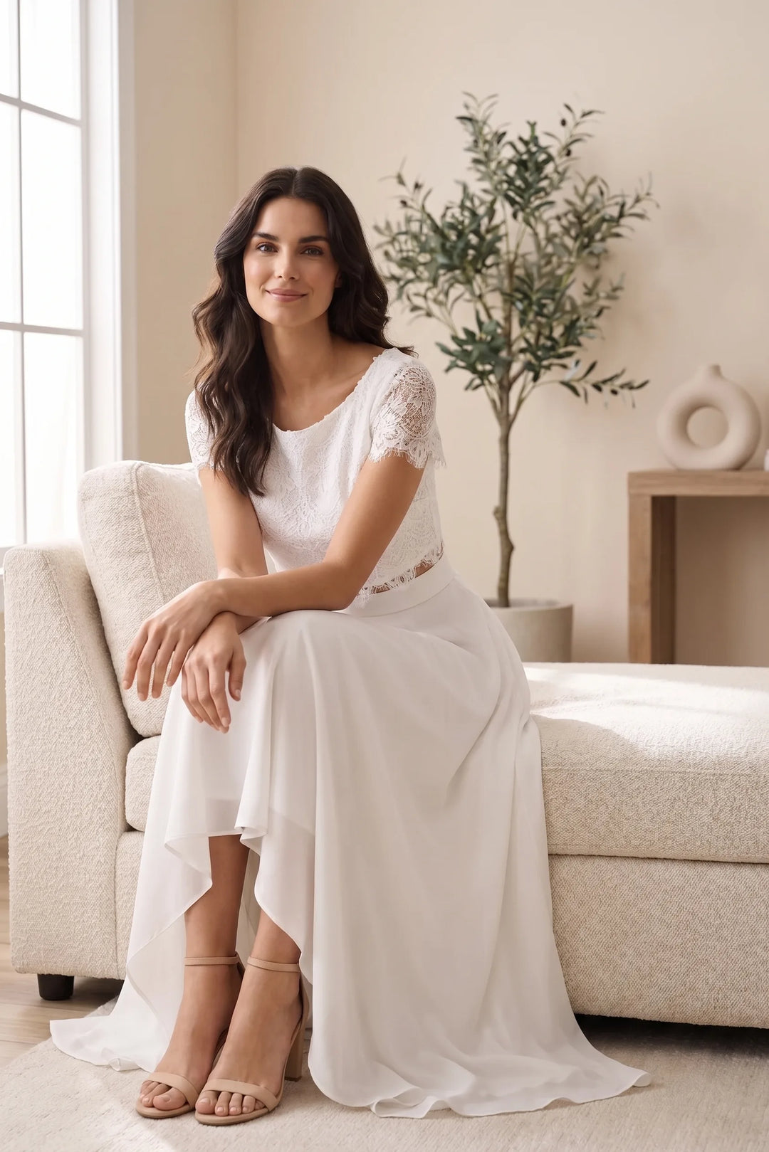 Model wearing a white lace crop top and midi skirt set in an outdoor lifestyle scene