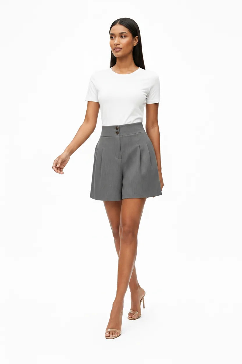 Dark grey pleated Bermuda shorts on a model in natural movement