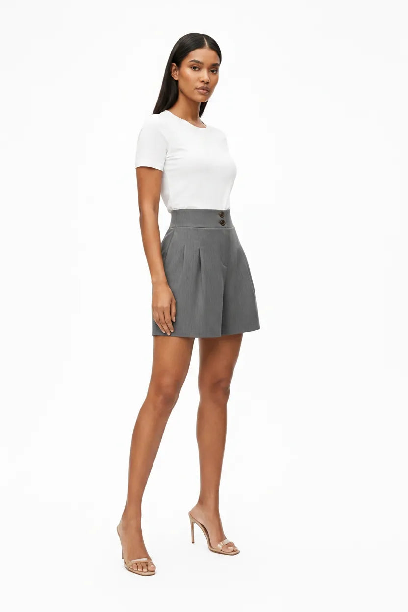 Dark grey pleated Bermuda shorts on a model in a three-quarter turn