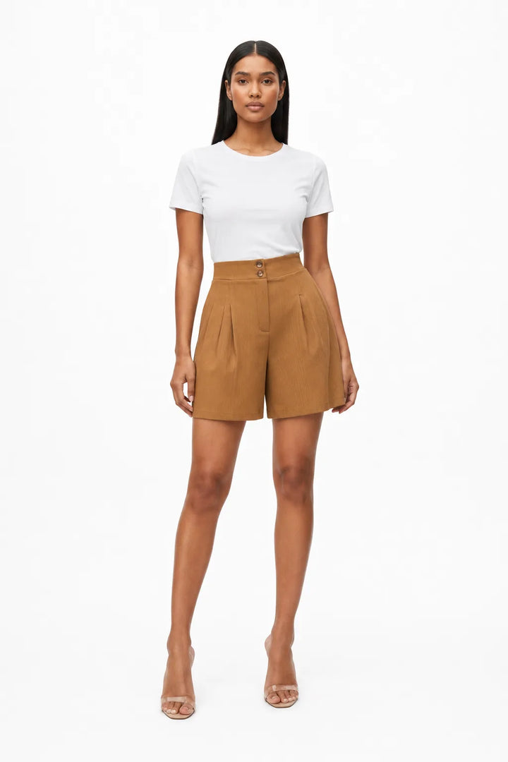 Khaki pleated Bermuda shorts on a model in a contrapposto stance