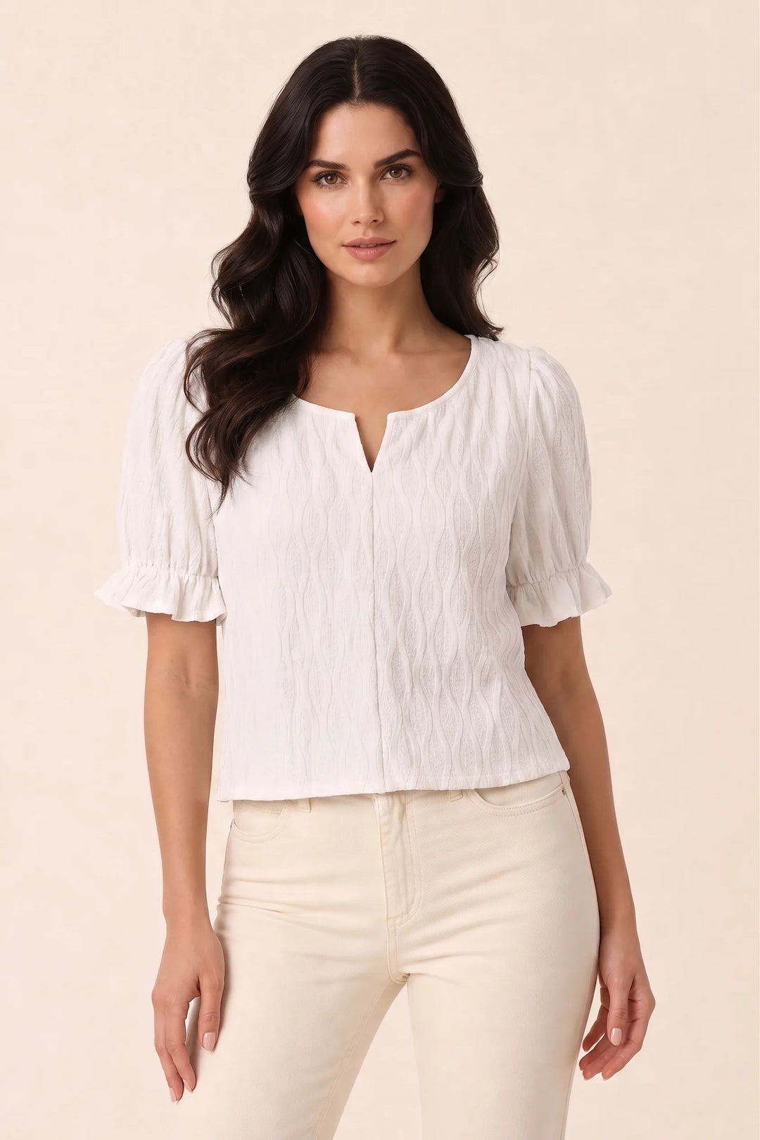 White puff sleeve blouse on model in contrapposto stance, relaxed hip shift with arms at sides