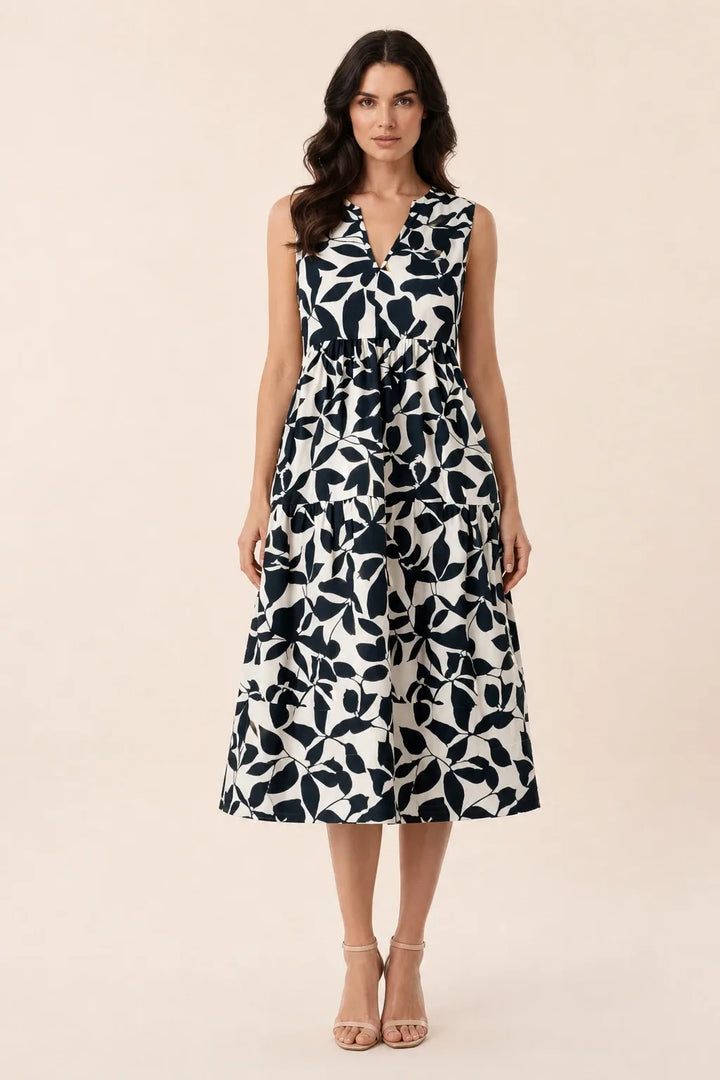 Black floral tiered midi dress on model in contrapposto stance