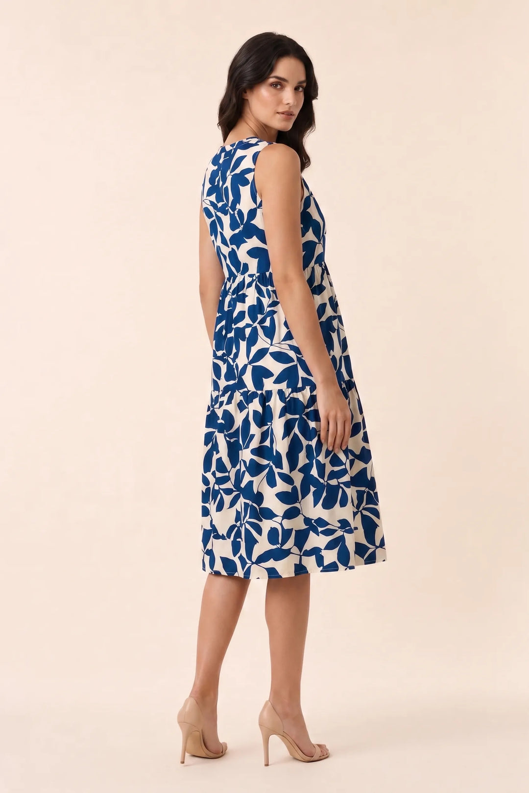Blue floral tiered midi dress on model in three-quarter turn