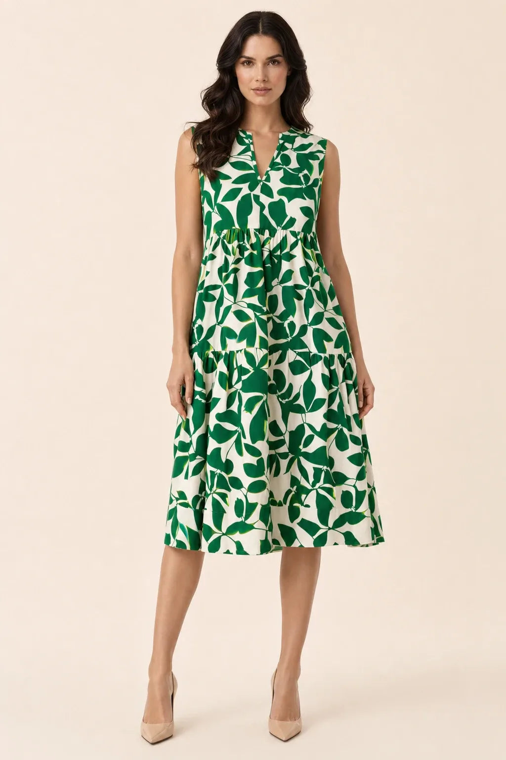 Green floral tiered midi dress on model in contrapposto stance