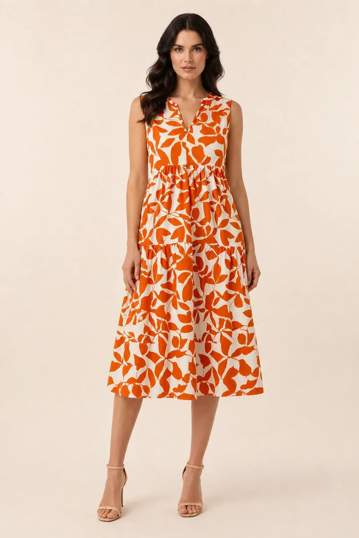 Orange floral tiered midi dress on model in contrapposto stance
