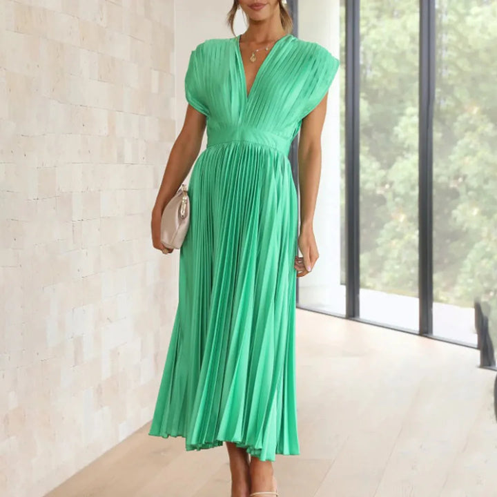 Model in champagne pleated midi dress showing upper bodice detail