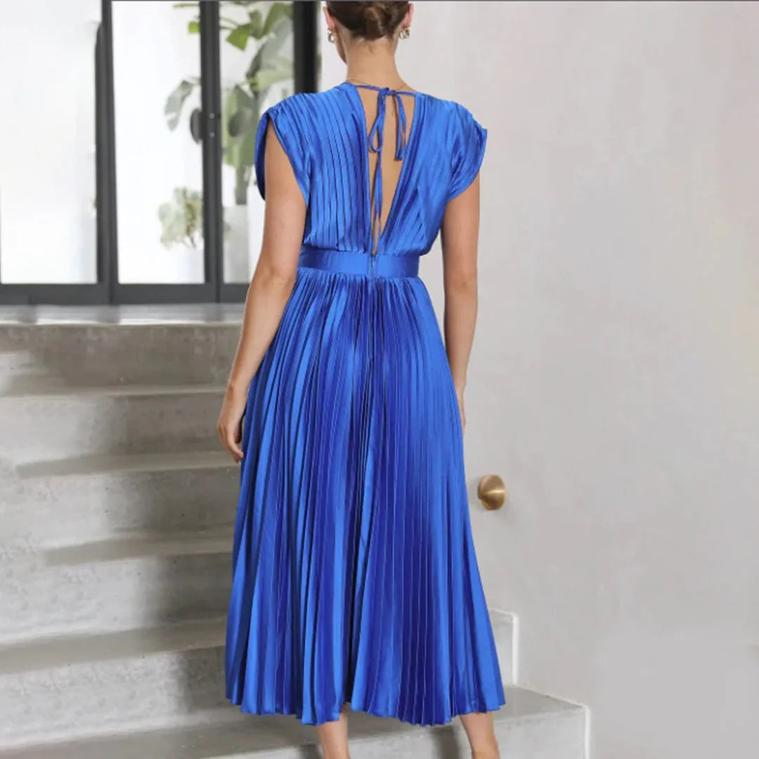 Model in champagne pleated midi dress shown in a full-length stance