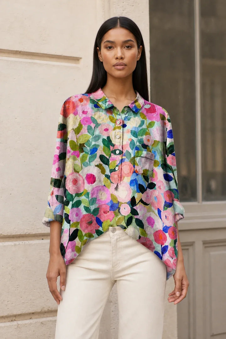 Floral print blouse with small blooms on a model in a relaxed contrapposto stance