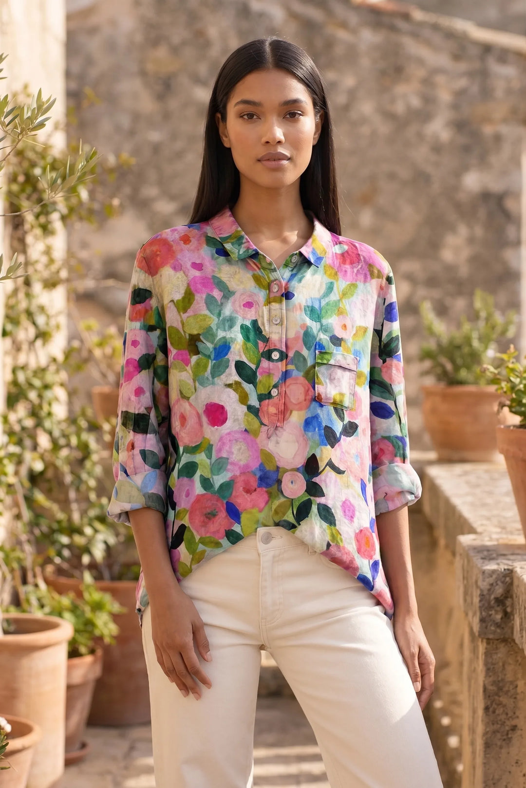 Model wearing a floral print blouse in a casual lifestyle setting