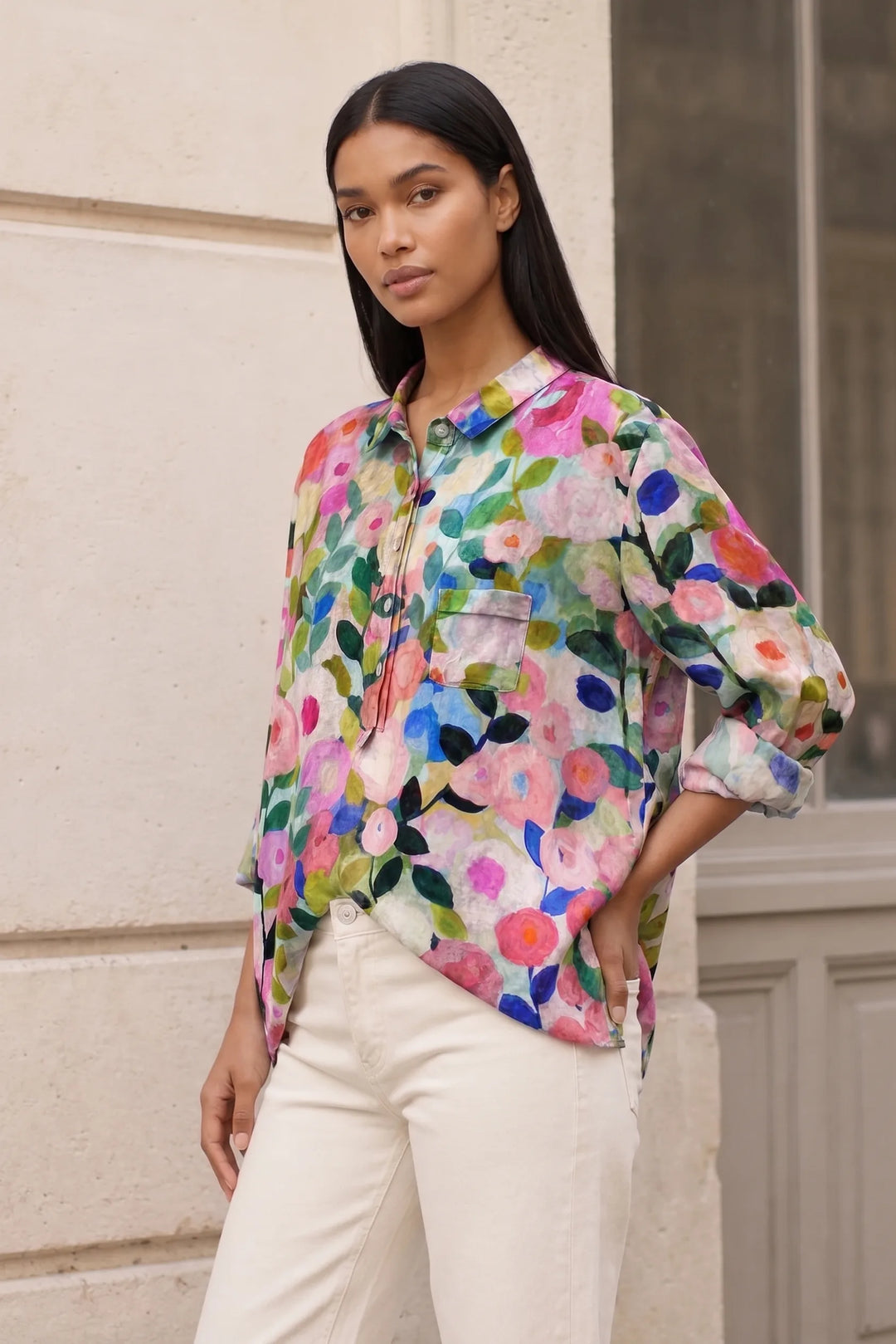 Floral print blouse with small blooms on a model in a three-quarter turn