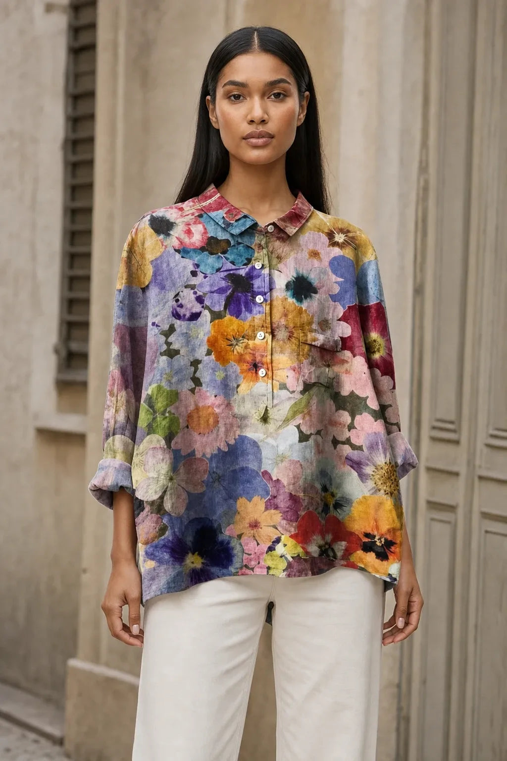 Floral print blouse in a fourth colorway on a model in a contrapposto stance