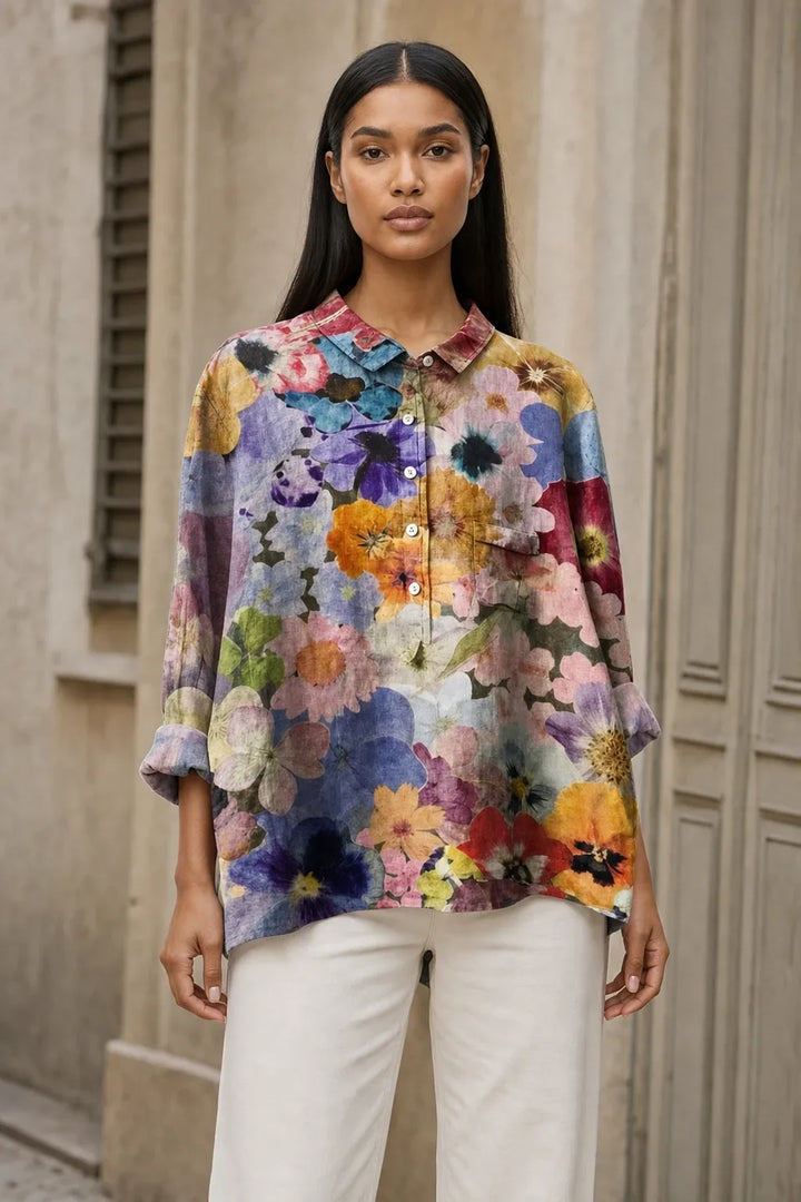 Floral print blouse in a fourth colorway on a model in a contrapposto stance