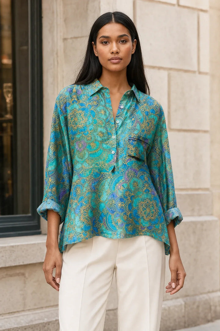 Floral print blouse in a sixth colorway on a model in a contrapposto stance