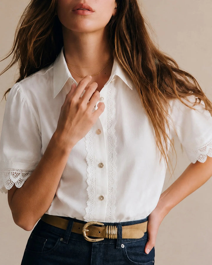 White lace trim blouse on model in side profile