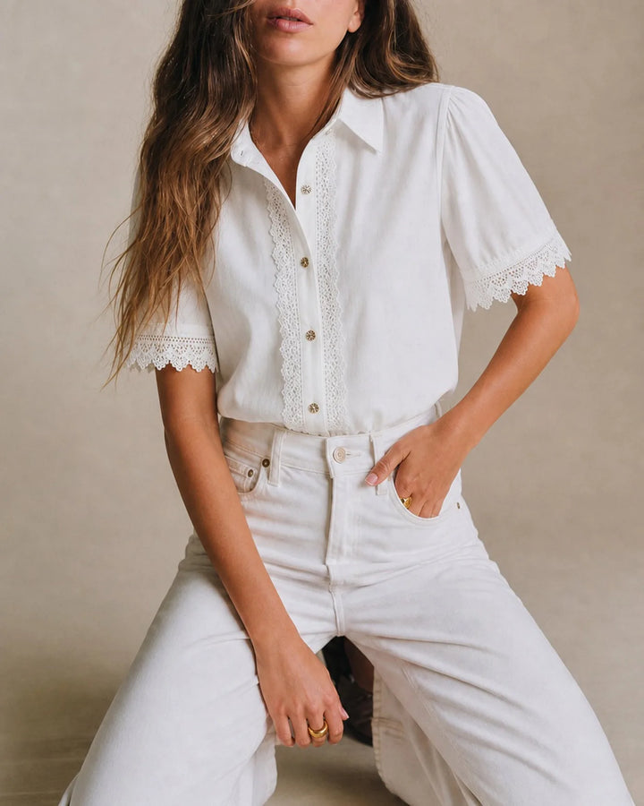 White lace trim blouse on model in three-quarter turn