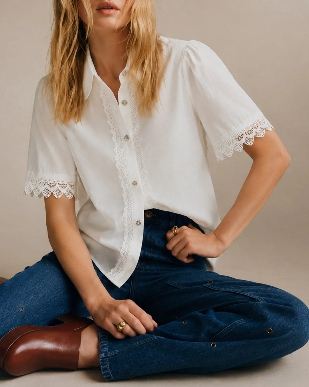 White lace trim blouse on standing model