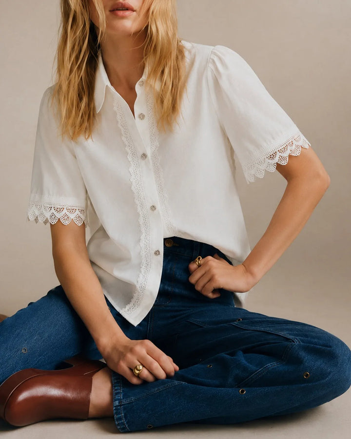 White lace trim blouse on standing model