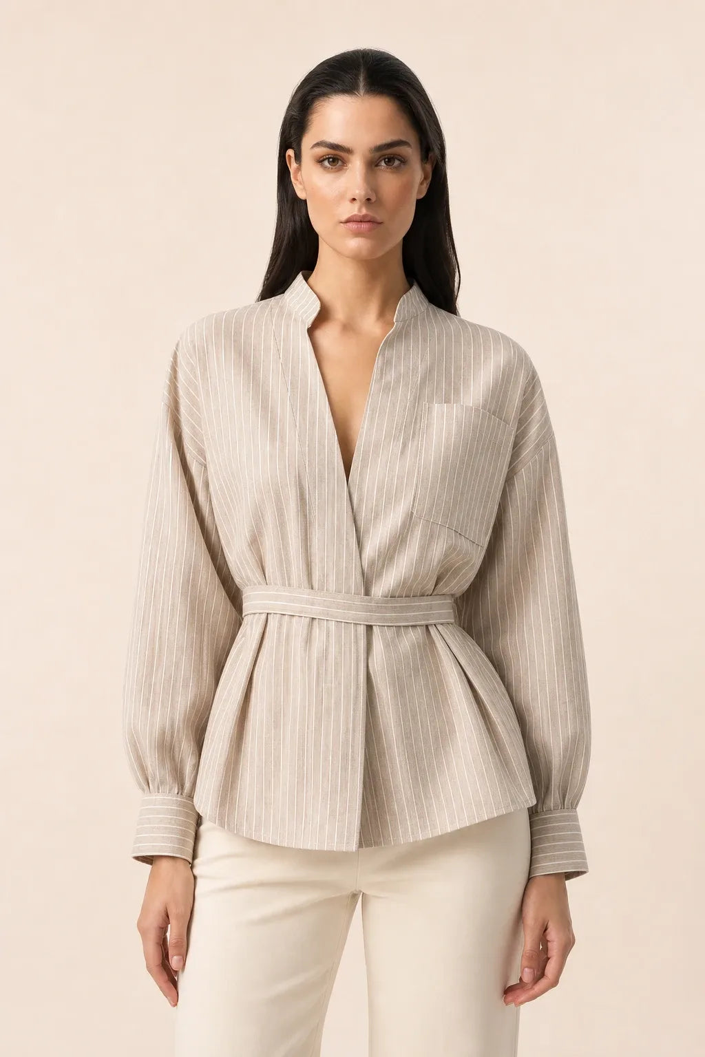 Brown belted wrap blouse on model in contrapposto stance