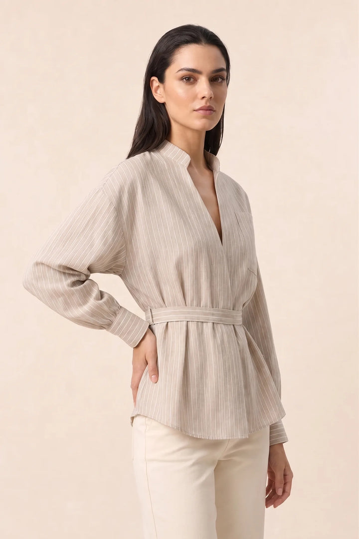 Brown belted wrap blouse on model in three-quarter turn