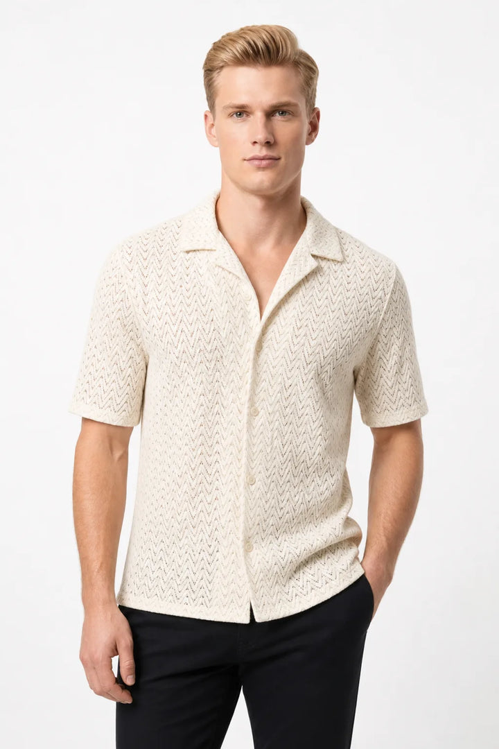 Beige chevron knit camp shirt on model in contrapposto stance