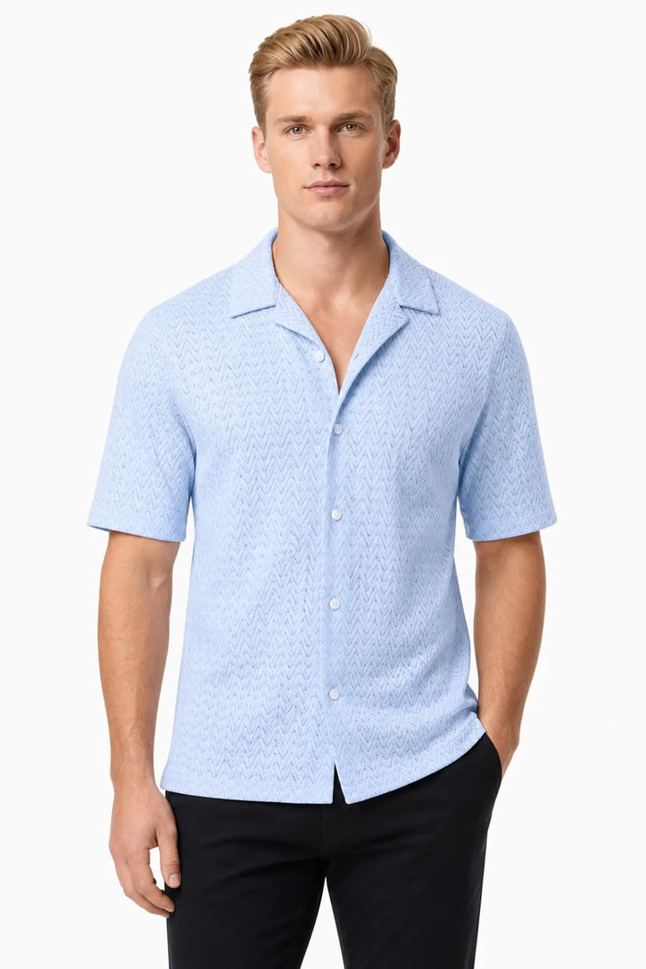Light blue chevron knit camp shirt on model in contrapposto stance