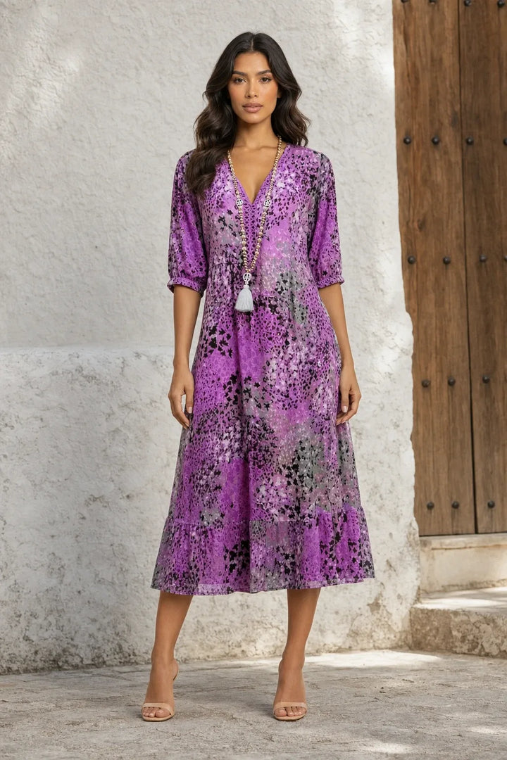 Lavender purple floral boho midi dress on a model in a contrapposto stance