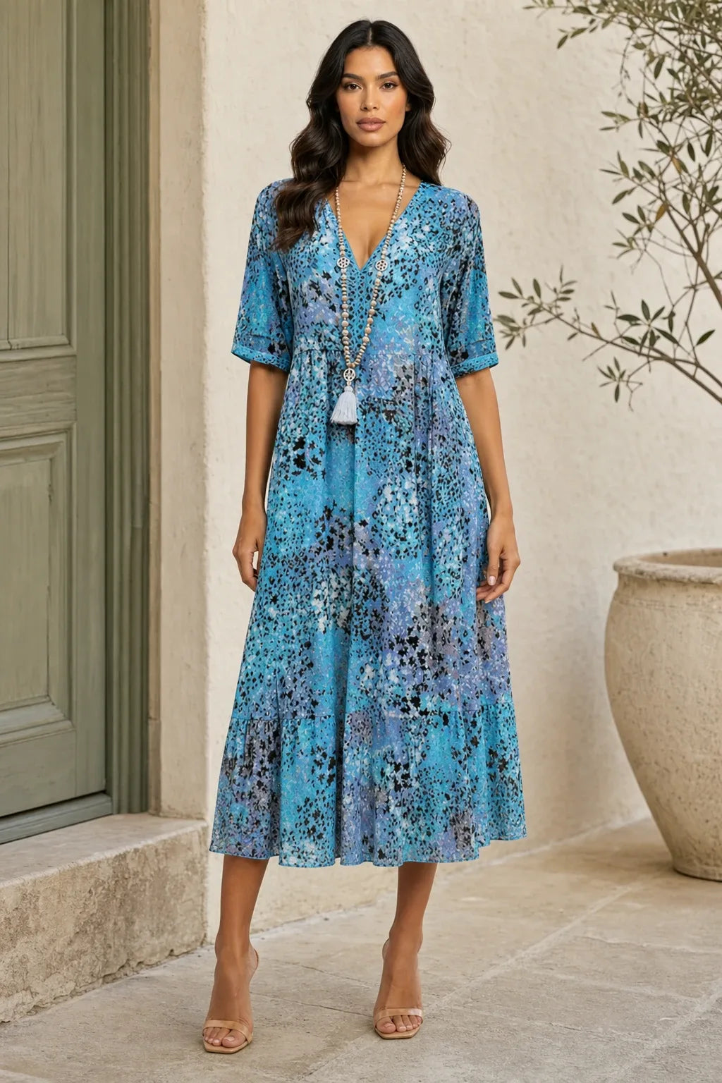 Ocean blue floral boho midi dress on a model in a contrapposto stance