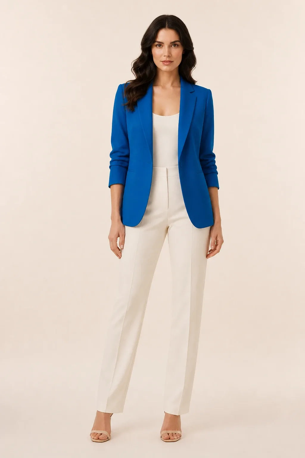 Blue open-front blazer with notch lapels worn by a model in a contrapposto stance