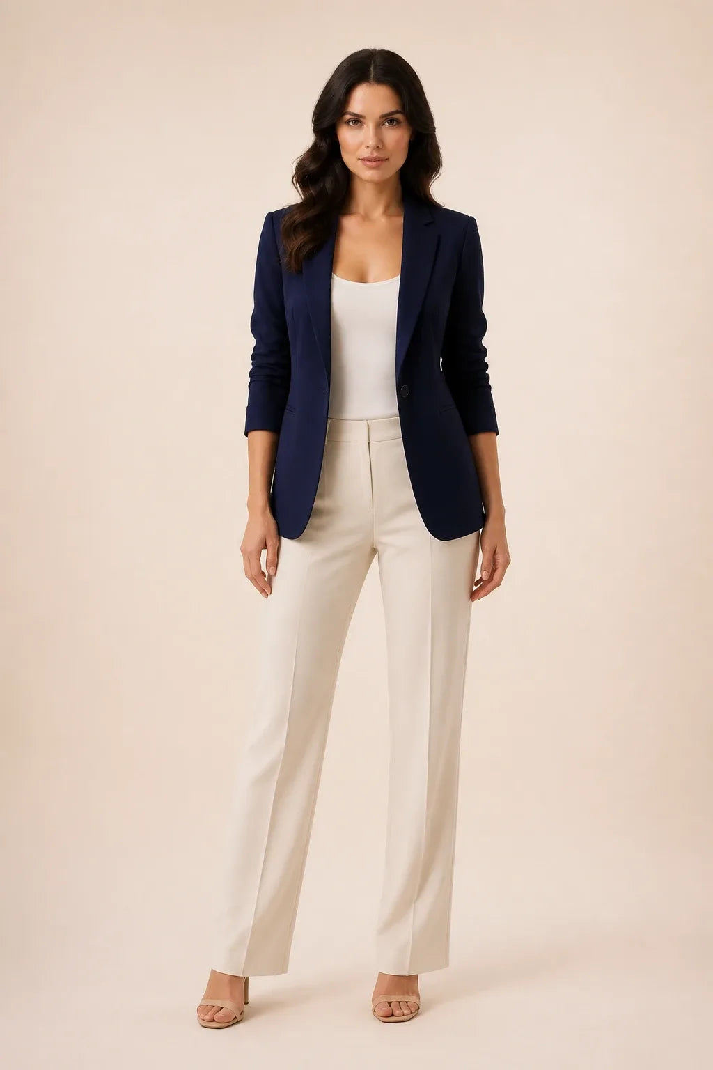 Dark blue open-front blazer with notch lapels worn by a model in a contrapposto stance