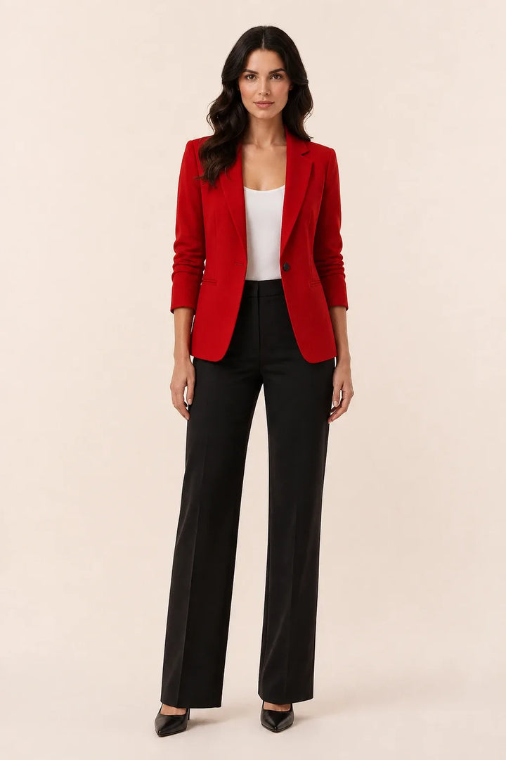 Dark red open-front blazer with notch lapels worn by a model in a contrapposto stance