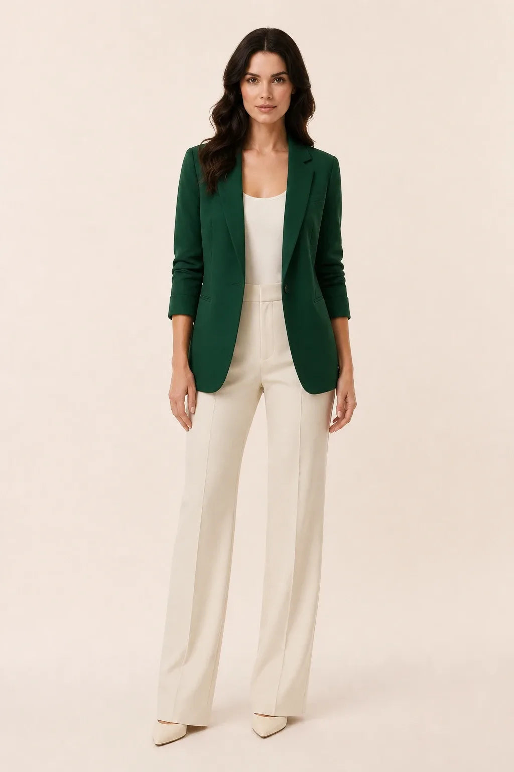 Green open-front blazer with notch lapels worn by a model in a contrapposto stance