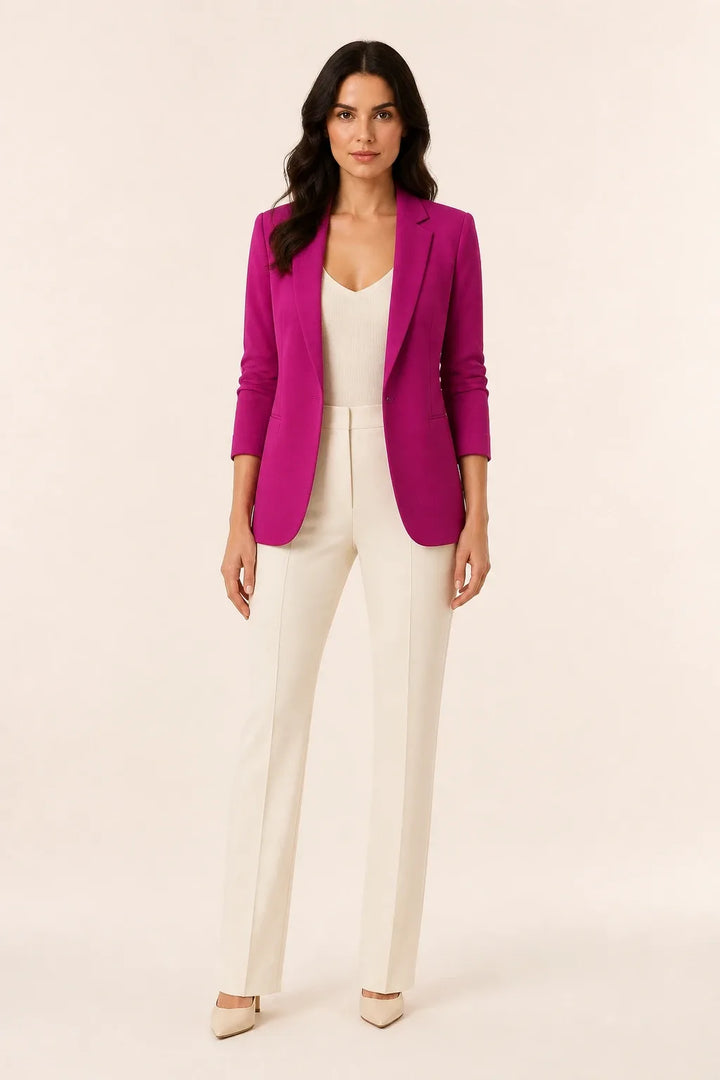 Purple open-front blazer with notch lapels worn by a model in a contrapposto stance