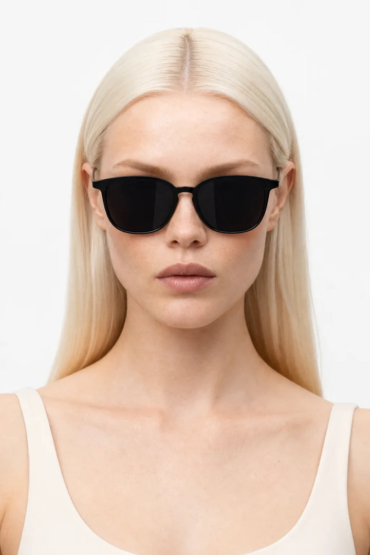 Woman wearing black square acetate sunglasses with UV400 protection, front-facing close-up