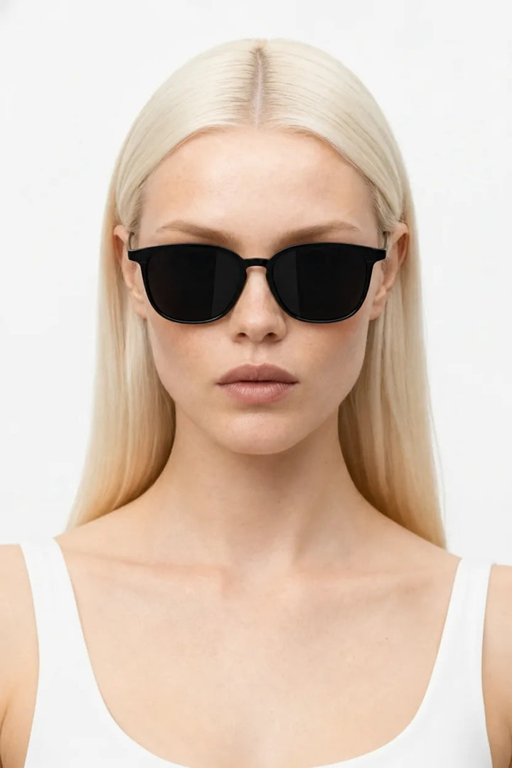 Woman wearing white square acetate sunglasses with UV400 protection, front-facing close-up