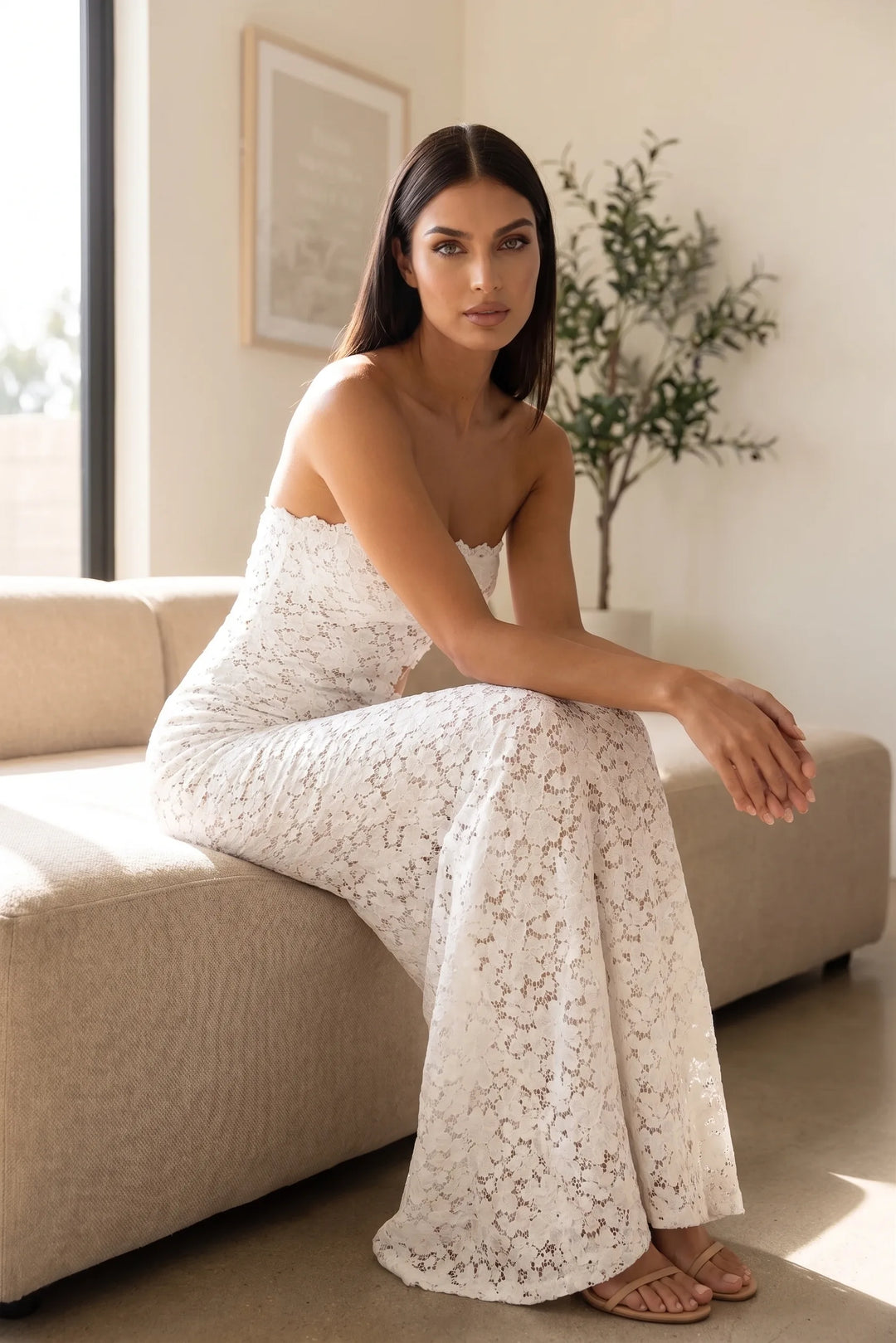 Model wearing white lace cut-out gown in an outdoor lifestyle setting