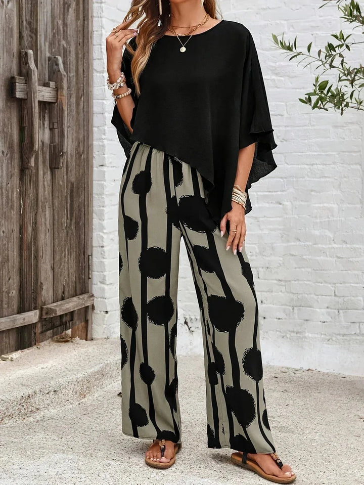 Black batwing sleeve top and wide-leg trouser co-ord on model facing forward