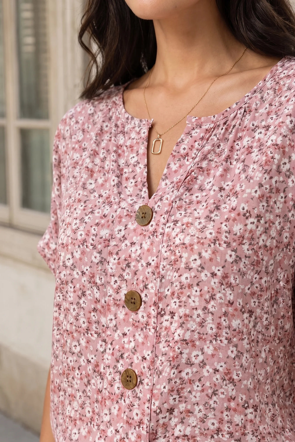 Close-up detail of a ditsy floral button blouse