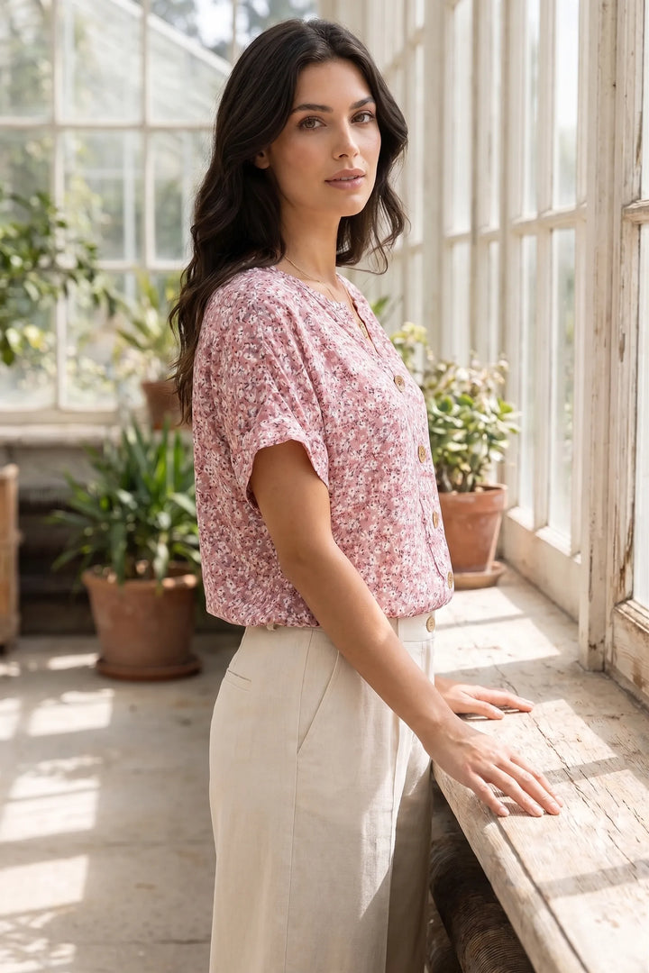 Model wearing a ditsy floral button blouse in a lifestyle setting